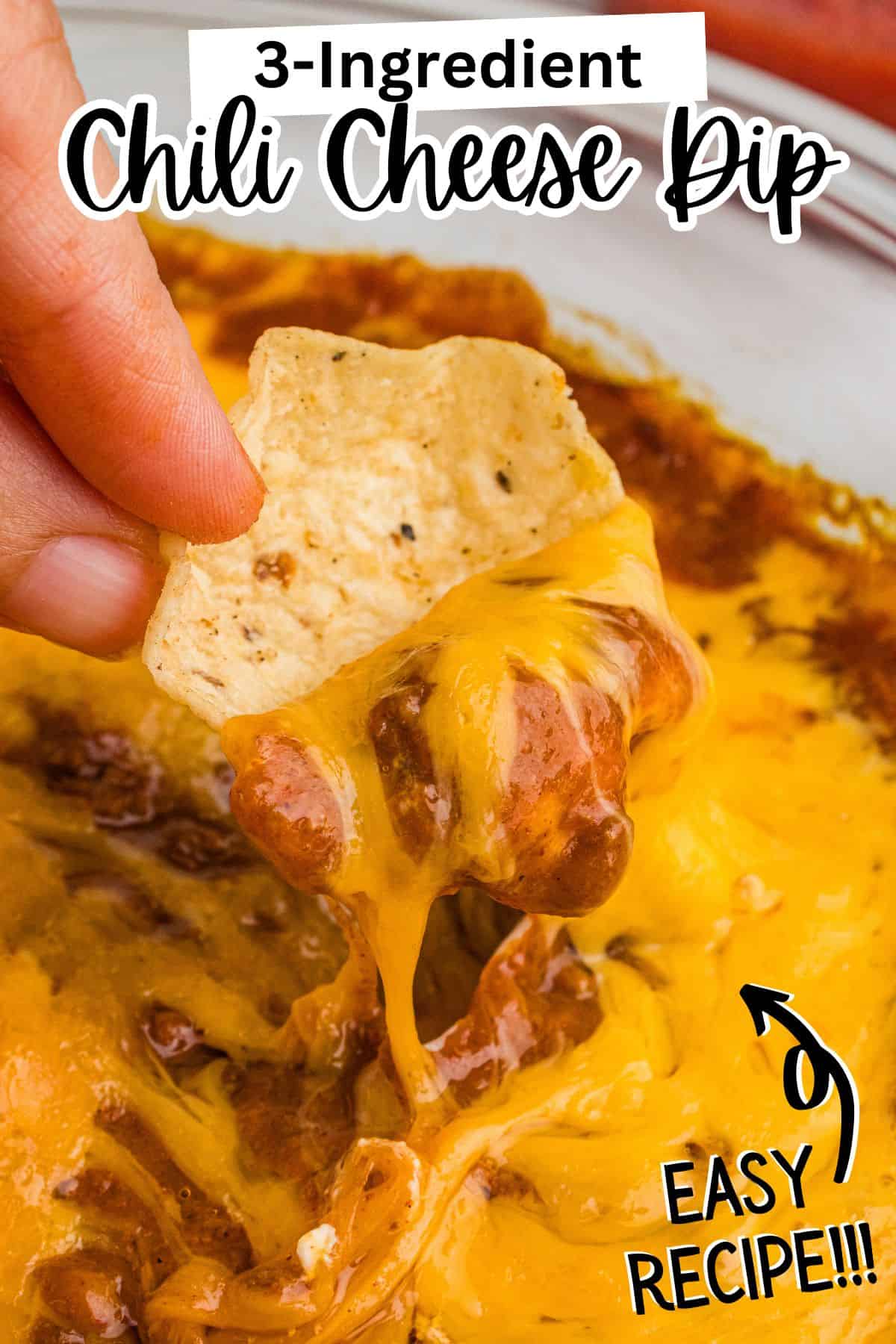 Tortilla chip dipped into gooey chili cheese dip. Text reads 