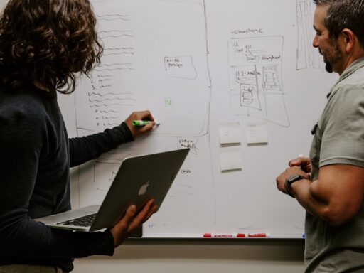 Man Wearing Gray Polo Shirt Beside Dry-erase Board